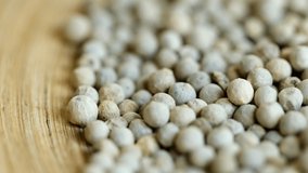 Close-up video of a slowly rotating white pepper