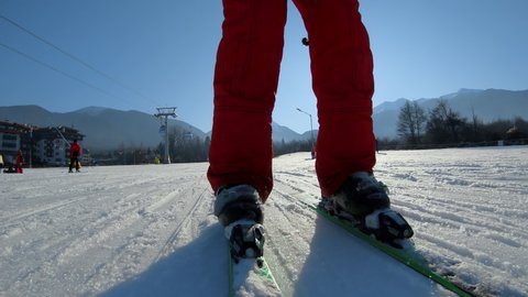 Bansko, Bulgaria - 12 Feb, 2021: Skier on go down the ski track along gondola ski lift