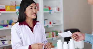 Pharmacist holding receive paper list medicine from customer and talk about details in pharmacy, health care  business concept 4k video,