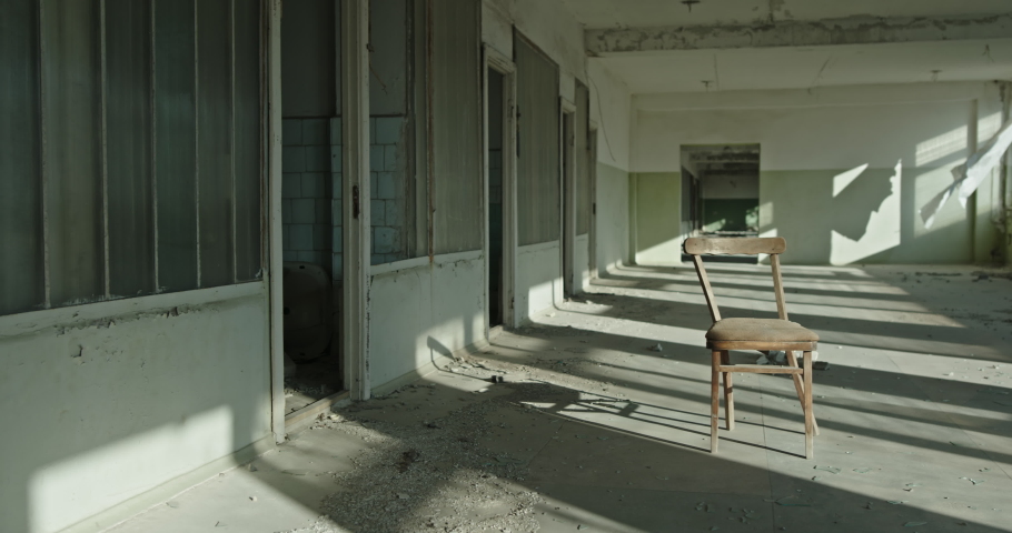 Empty chair in room of abandoned building