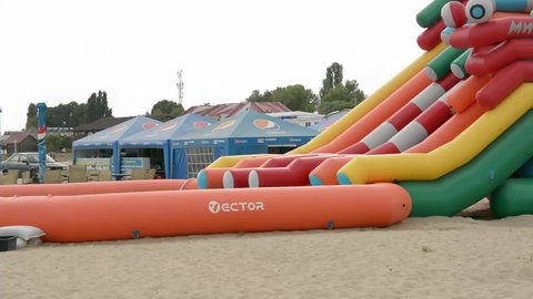 Zatoka, Odessa, Ukraine - September 1, 2021: A boy rides on the inflatable water slides, 29.97 fps
