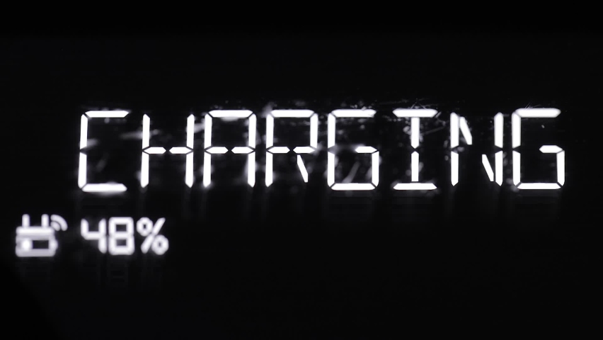 Charging sign on an lcd screen glowing in the dark