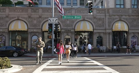 Beverly Hills, CA USA - September 7, 2021: Tourists crossing Wilshire Boulevard in front of the Beverly Wilshire Hotel, aka the Pretty Woman Hotel