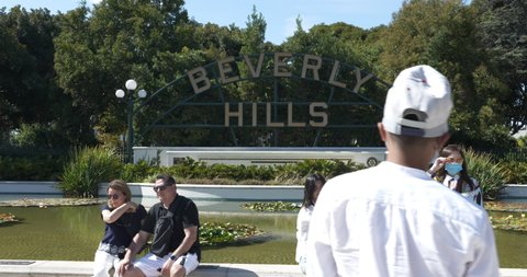 Beverly Hills, CA USA - September 7, 2021: Tourists taking pictures in front of the iconic Beverly Hills sign
