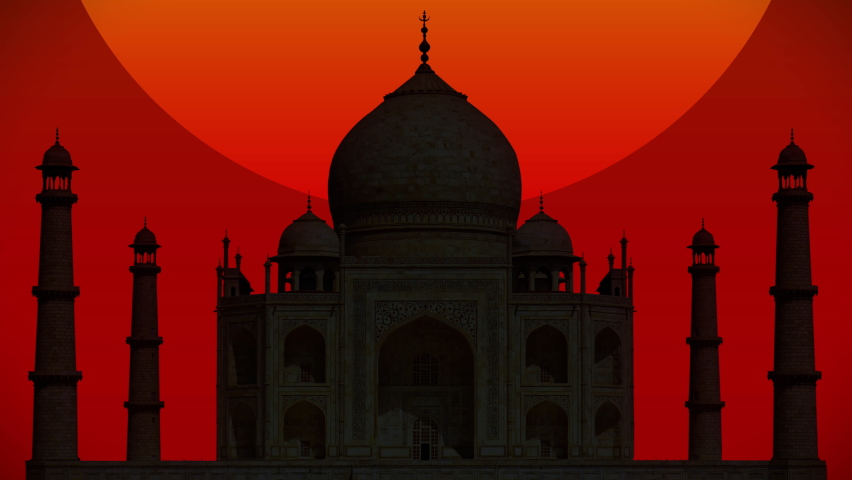 a giant red sun setting behind a silhouette of the taj mahal in india