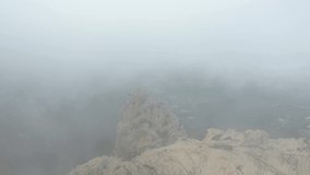 View from above, drone point of view, stunning aerial video of a drone flying over a granite mountain during a cloudy day. San Pantaleo, Sardinia, Italy.