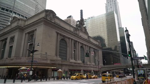 NEW YORK, USA - MAY, 18, 2021: Grand central terminal building. Yellow NYC taxi parked near entrance to railway station. Midtown Manhattan.