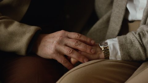 Senior couple hands closeup. Old arm holding each other indoors. Married older man and woman hands. Care hope love family relationship concept. Tender elderly family support together