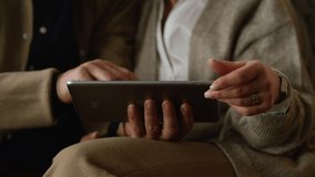 Senior couple hands using tablet computer closeup. Closeup unknown old aged people touching digital device screen at home. Unrecognizable family chatting online reading news looking photos on pad - Powered by Shutterstock - Get 15% off with code: PIKWIZARD15