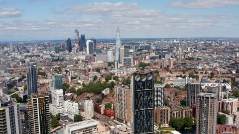 Aerial footage of Strata skyscraper with wind turbines on top. Modern downtown skyscrapers in City financial hub. London, UK