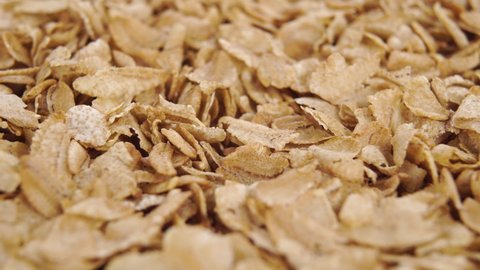 Uncooked dry spelt flakes. Macro. Rotation. Healthy superfood