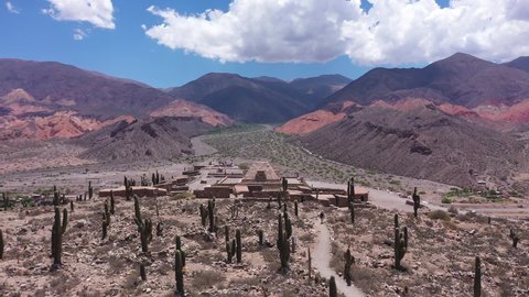 Aerial view of a small village with an Inca temple in the middle of a mountainous and desert valley in Jujuy, Pucará Argentina. 4K footage of travel and tourism concept in South America.