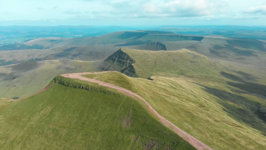 Aerial drone shot of Pen Y Fan and Cribyn mountain peaks in Brecon Beacons National Park, Wales Royalty-Free Stock Footage #1079835527