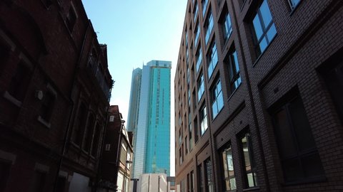 BIRMINGHAM, UK - 2021: Birmingham city centre low aerial reveal with big buildings