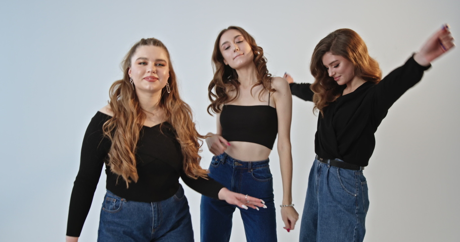 Trendy young women dancing together
