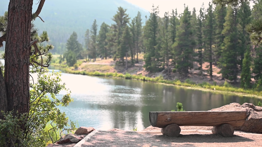 Woman taking pictures along Lily Lake in Rocky Mountain National Park