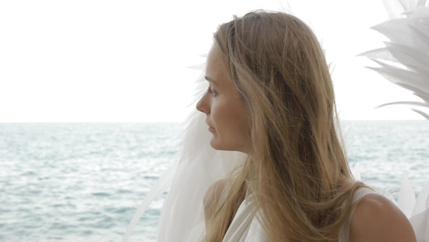 Female model in the image of an angel with wings