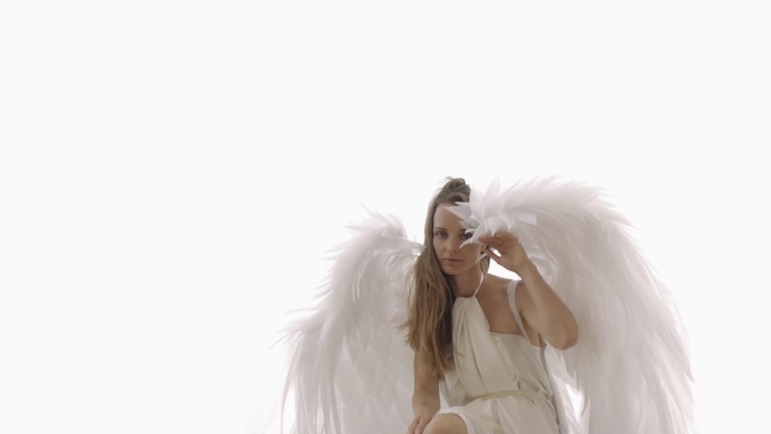 Female model in the image of an angel with wings