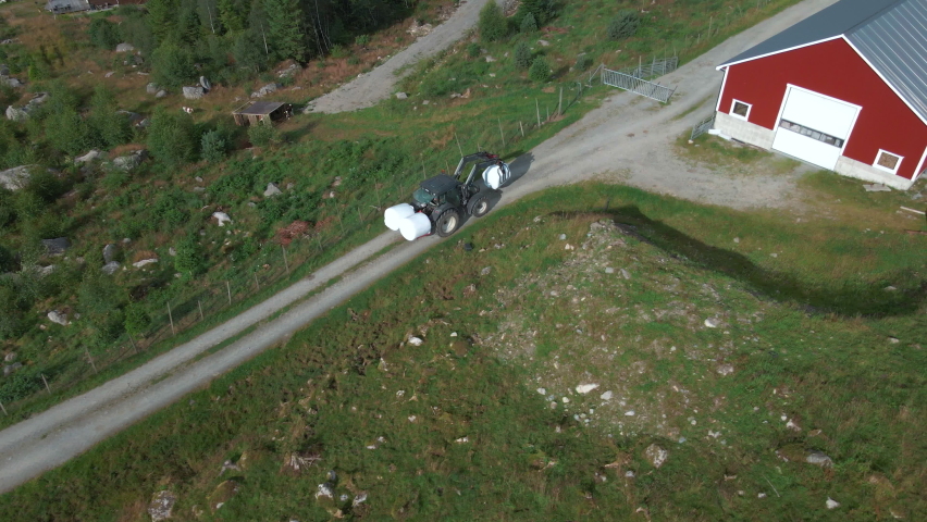 Tractoring baled silage to the barn for storage