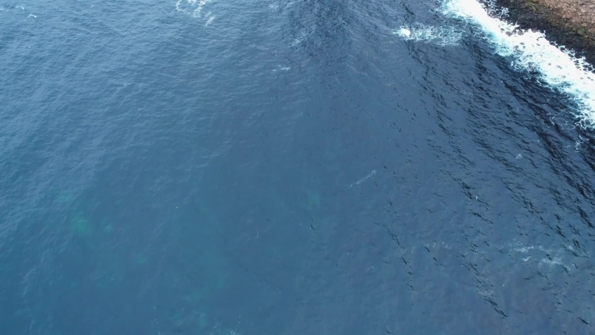 Slow motion, reveal shot of the Old Man of Hoy, a 449ft high sea stack on Hoy, Orkney, Scotland.