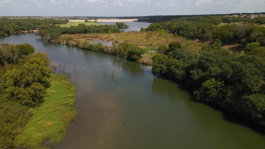 Aerial view of luxurious Central Texas river and surrounding nature trails, drone 4K