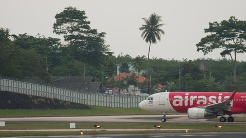 PHUKET, THAILAND - NOVEMBER 27, 2017: Low-cost airline AirAsia is taxiing to the departure runway at Phuket International Airport (HKT). Airbus A320, HS-BBC on the airfield