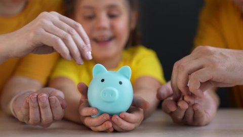 piggy bank. happy family a save money. business investment finance piggy bank concept. happy family hands holding piggy bank. kid and parents put coins lifestyle in investment money box