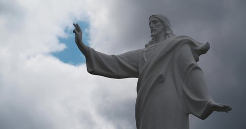 Jesus Christ with hand raised for blessing. Statue of Jesus of Nazareth and heaven. Cinema 4K Timelapse