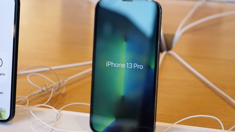 Paris, France - Sep 24, 2021: Slow pan to improved retina display with ProMotion 120 hz on iPhone 13 Pro at the Apple Store as latest new 5G iPhone 13, 13 Pro, new iPad and iPad mini go on sale