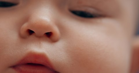 Baby's face close-up, lips and eyes of a newborn.
