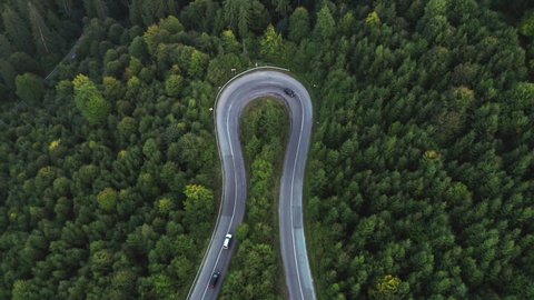Cars Driving At Hairpin Turn In Mountain Pass With Lush Forest In Romania - Hairpin Corner. - aerial