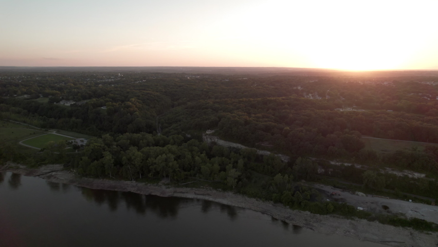 Slow aerial turn to stunning sunset over Mississippi River