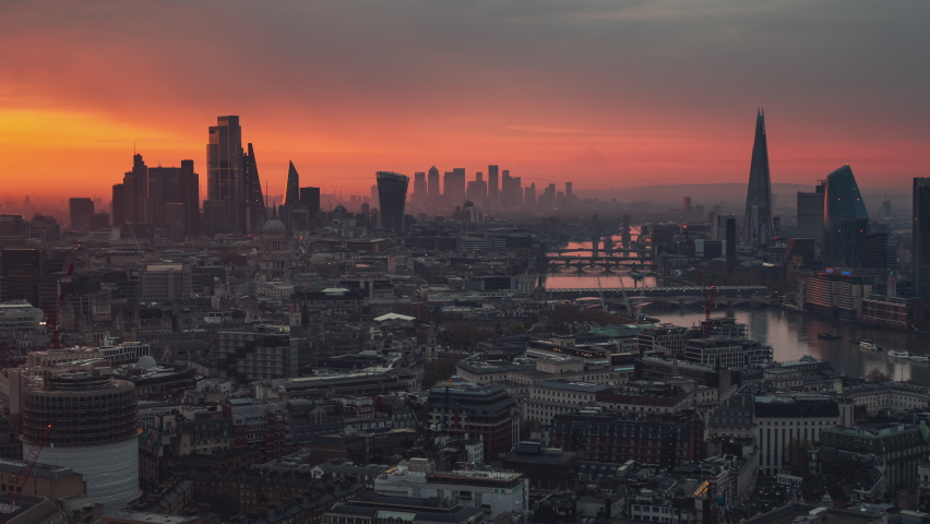 Establishing Aerial View Shot of London UK, United Kingdom, epic red and yellow, moody sunrise over capital skyline
