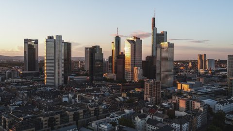 Golden Sunset, Establishing Aerial View Shot of Frankfurt am Main De, financial capital of Europe, Hesse, Germany, orbiting with reflections