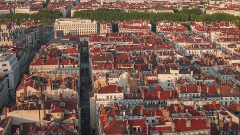 Establishing Aerial View Shot of Lyon Fr,  Auvergne-Rhone-Alpes, France, golden light on the roofs of houses in old town