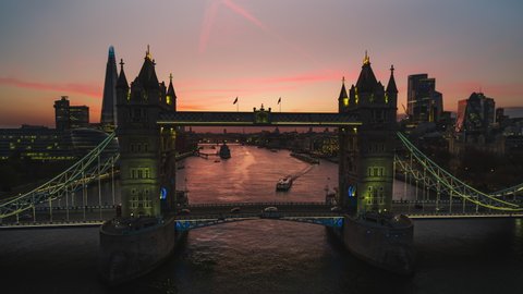 Magnificent Sunset, Establishing Aerial View Shot of London UK, Tower Bridge, United Kingdom, orbiting close to bridge