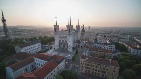 Lyon, France - circa 2021, Establishing Aerial View Shot of Lyon Fr, Auvergne-Rhone-Alpes, France, Basilica of Notre Dame de Fourviere, superb blissful light, pull back
