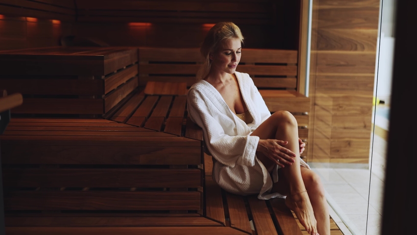 Cinematic video of a woman in the sauna. Young adult enjoying a day at the spa resort | Shutterstock HD Video #1079883557