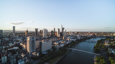 Frankfurt, Germany - circa 2021: Golden Sunset, Establishing Aerial View Shot of Frankfurt am Main De, financial capital of Europe, Hesse, Germany, rise up, revealing crane shot