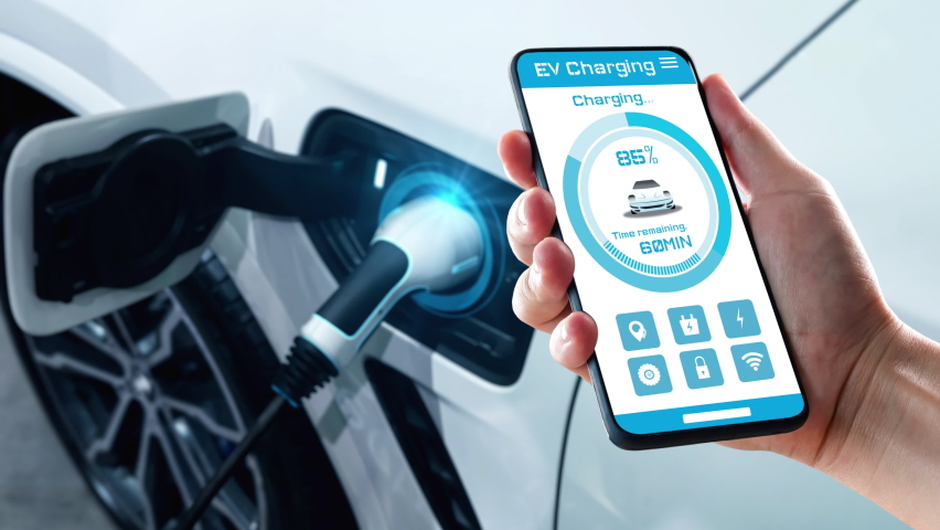 EV charging station for electric car with mobile app display charger status . The electric power is produced from sustainable resources to supply to charger station in order to reduce CO2 emission . Royalty-Free Stock Footage #1079889104