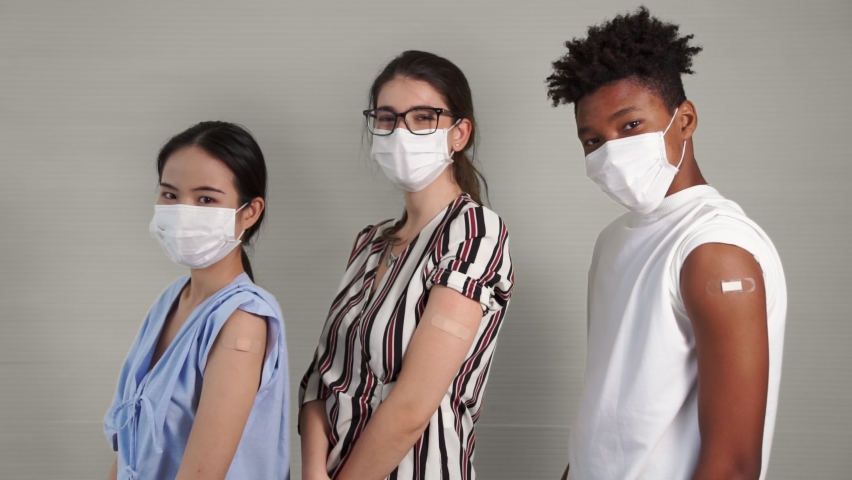 Diverse group of people showing COVID-19 vaccine bandage merrily in concept of coronavirus vaccination program to vaccinate citizen . Royalty-Free Stock Footage #1079889119