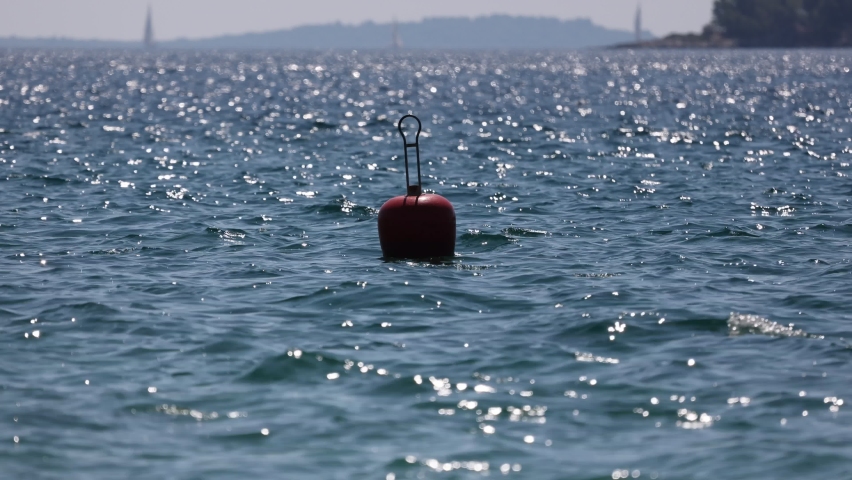 Buoy sways on the waves of the sea. Royalty-Free Stock Footage #1079890328