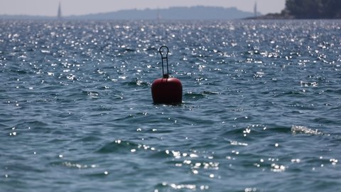 Buoy sways on the waves of the sea.