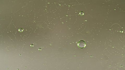 Macro Shot of air Bubbles in Transparent Cosmetic Liquid Gel Cream. Green Cosmetic Fluid texture With Bubbles. Slow motion 