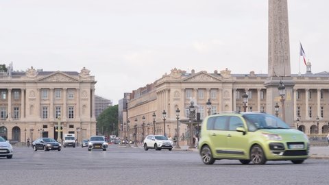 Paris , France - 09 26 2021: Vehicles Driving At Place de la Concorde With Luxor Obelisk