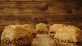 Eastern sweets baklava on wooden background, zoom in video