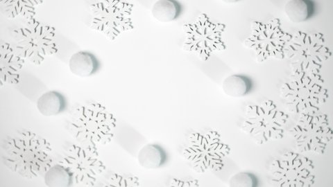 Christmas toy white snowflakes rotate on white background with place for text. New Year composition video greeting card 4k footage