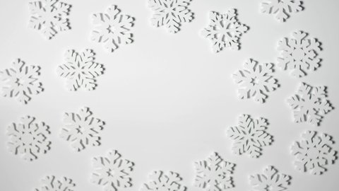 Christmas toy white snowflakes frame rotate on white background with place for text. New Year composition video greeting card 4k footage