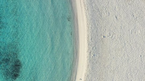 View from above, stunning aerial view of a white sand beach bathed by a turquoise, crystal clear water. Prince Beach (Spiaggia del Principe) Sardinia, Italy.