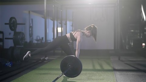 Fitness woman train landmine single leg romunian dead lift with barbell 4K